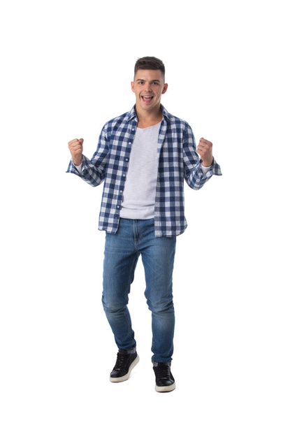 Young excited man happy smile looking at camera, hold arm hands fist raised up gesture, isolated over white background - Photo, Image