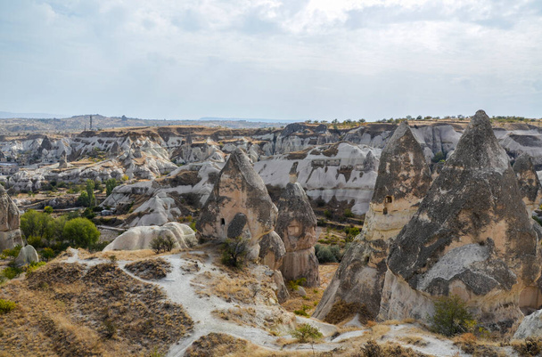 Unique fancy geological mountain formations with dovecotes of the Pigeon valley in Goreme, Cappadocia, Turkey - Foto, afbeelding