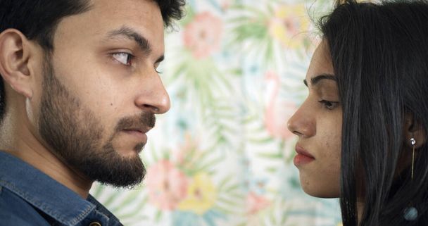A young Indian couple strictly looking at each other during a serious argument - Foto, Imagen