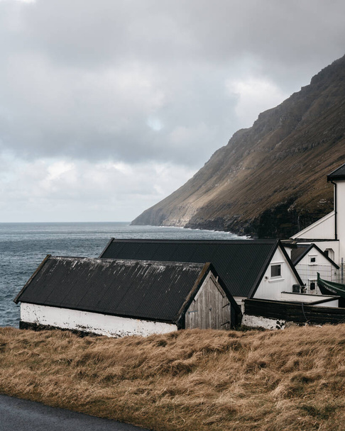 A beautiful photo of white coastal houses in Bour, Faroe Islands - Zdjęcie, obraz