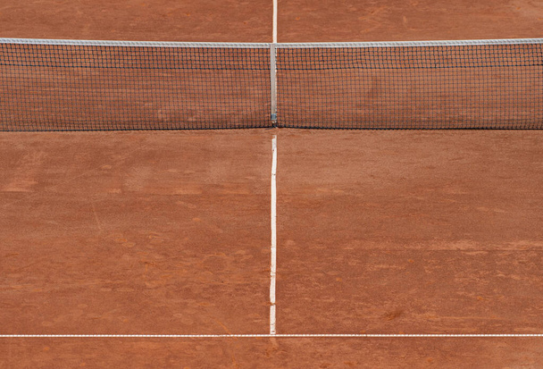 Empty clay tennis court and net. Professional sport concept. Horizontal sport poster, greeting cards, headers, website - Photo, Image