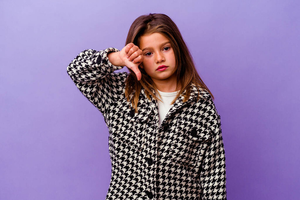 Little caucasian girl isolated on purple background Little caucasian girl isolated on purple background showing a dislike gesture, thumbs down. Disagreement concept. - Photo, image