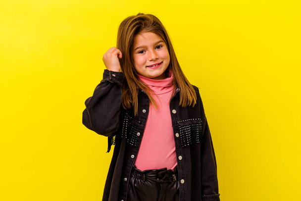 Little caucasian girl isolated on yellow background laughing about something, covering mouth with hands. - Photo, Image