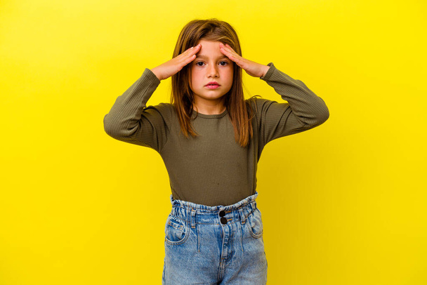 Little caucasian girl isolated on yellow background receiving a pleasant surprise, excited and raising hands. - Photo, Image