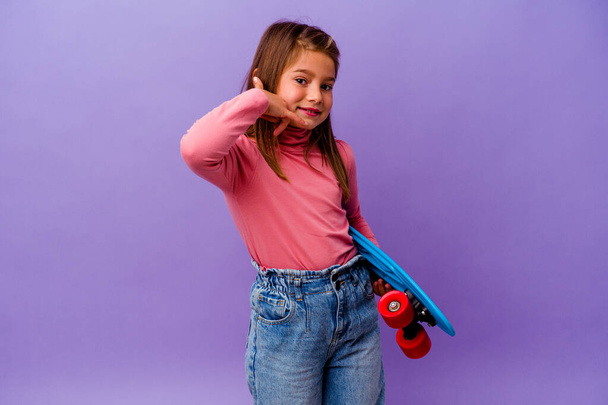 Little skater caucasian girl isolated on blue background showing a mobile phone call gesture with fingers. - Photo, Image