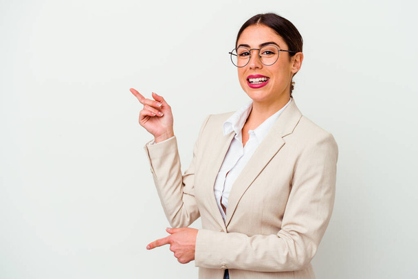 Young business caucasian woman isolated on white background excited pointing with forefingers away. - 写真・画像