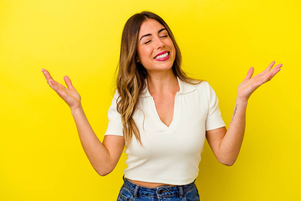 Young caucasian woman isolated on yellow background joyful laughing a lot. Happiness concept. - Valokuva, kuva