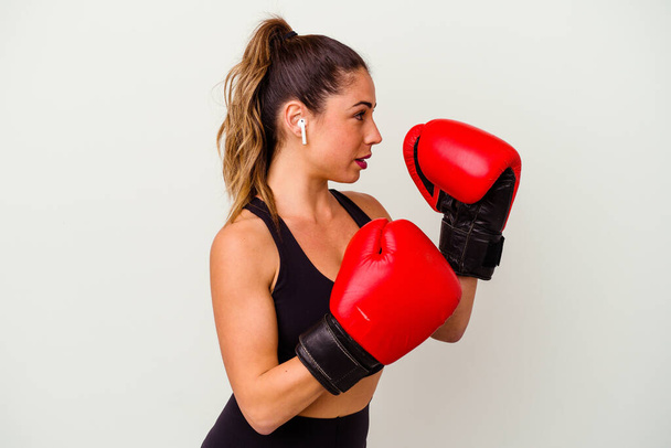 Young caucasian woman fighting with boxing gloves isolated on white background - Fotoğraf, Görsel