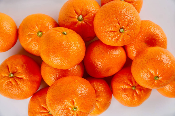 Fresh mandarin or tangerines on white background. Top view, close up. - Photo, Image