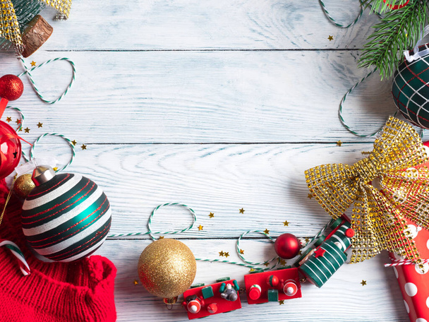 Christmas red, green and golden golden ornament frame on wooden background. New year festive mood - Φωτογραφία, εικόνα