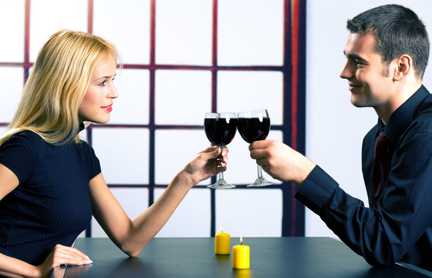 Young attractive happy smiling couple celebrating with red wine, - Foto, Imagen