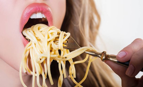 Close up sexy lips with noodles pasta. Female mouth eat spaghetti. - Fotografie, Obrázek