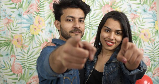 A shallow focus of a young Indian couple pointing at the camera - Fotografie, Obrázek