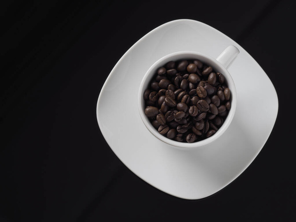 A cup of coffee beans isolated on black background - Foto, immagini