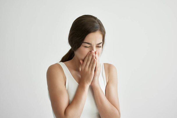 sick woman in white tank top handkerchief runny nose health problems cold flu - Фото, изображение