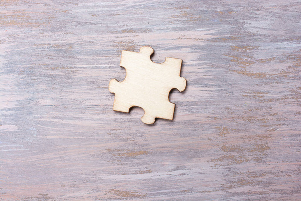 A wooden puzzle-like object on a wooden table - Fotó, kép