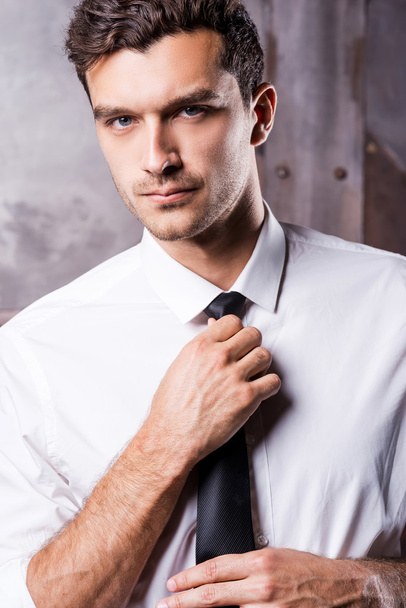 Man in formalwear adjusting his necktie - Zdjęcie, obraz