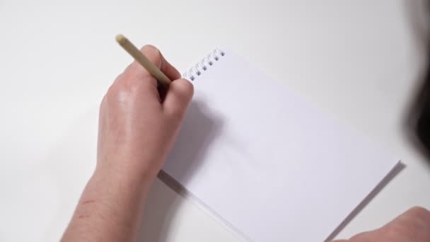 Unrecognizable left-handed woman writes goals for 2022 on paper - Footage, Video