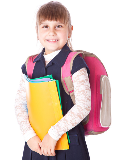 A girl in a backpack is holding folders in her hands - Foto, Imagen
