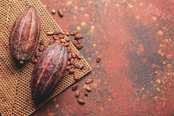 Composition with fresh cocoa fruits and beans on grunge background - Photo, Image