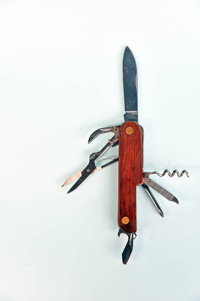 Pocket knife, with bottle opener, scissor,screwdriver,wine opener isolated on color background - Photo, Image