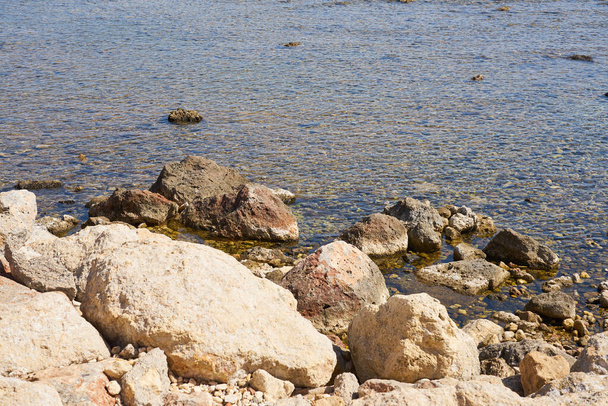 Stones on the shore of the warm tropical sea in Crete. - Photo, Image