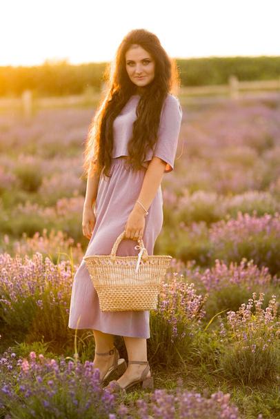 beautiful young woman in a field of lavenders  - Фото, зображення