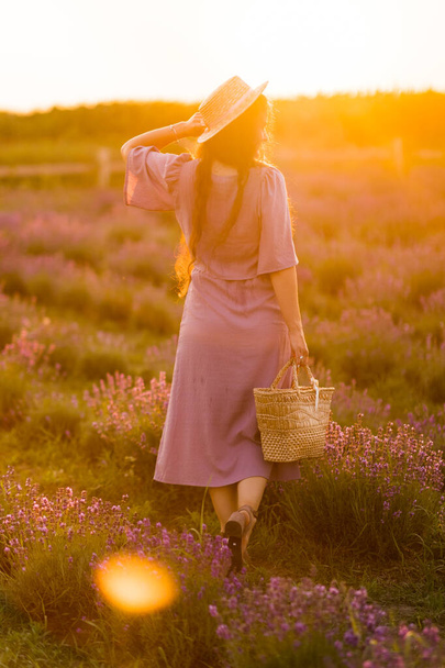 beautiful young woman in a field of lavenders  - Photo, image
