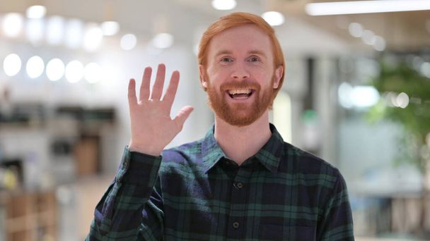 Portrait of Cheerful Redhead Man Talking on Video Call - Foto, afbeelding