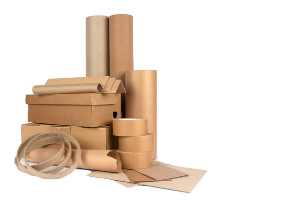 Set of different cardboard boxes, rolls of paper, paper edge protectors and tubes, sheets of paper and cardboard isolated for your presentation, catalogue or website. Sustainable packaging concept - Foto, Imagem
