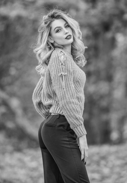 Style is all about balance. Woman wear warm sweater nature background defocused. Gorgeous lady feeling cozy in woolen sweater. Trendy clothes. Walk in fall park. Fancy girl wear knitted sweater - Photo, image