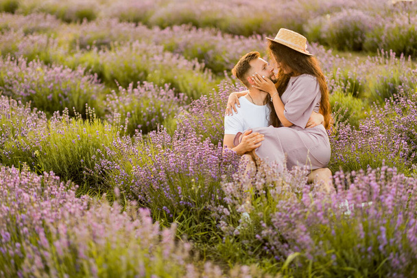 young couple in love kissing  in the field at sunset  - Foto, Imagen