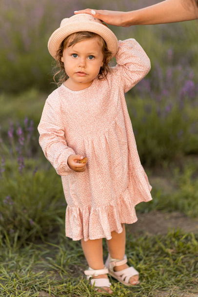 little girl in a hat  on the field  - Photo, image