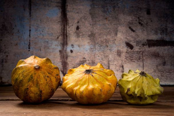 Decorative pumpkins on wooden table - Фото, зображення