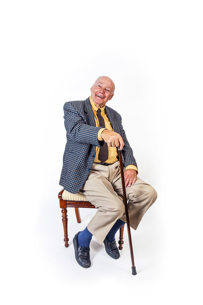 happy elderly man sitting in a chair  - Zdjęcie, obraz