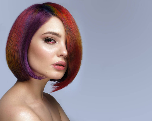 Beautiful woman with multi-colored hair and creative make up and hairstyle. Beauty face. - Foto, Imagen