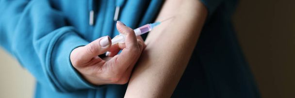 Woman making herself intravenous drug injection closeup - Photo, image