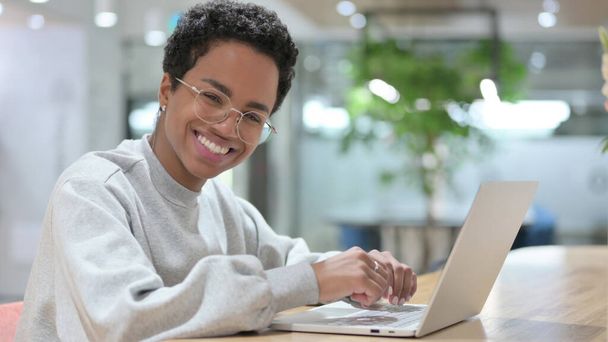 Young African Woman with Laptop Smiling at the Camera  - Photo, Image