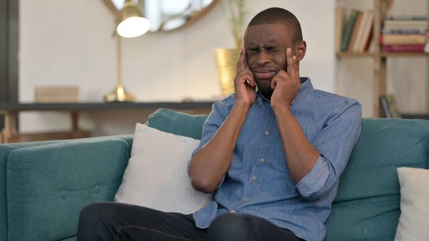 Stressed Young African Man with Headache on Sofa  - Φωτογραφία, εικόνα