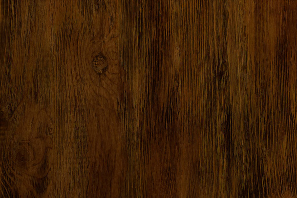 Donkere achtergrond bruine textuur gelakt hout. Leeg vlak oppervlak. Natuurlijk patroon op het bord. - Foto, afbeelding