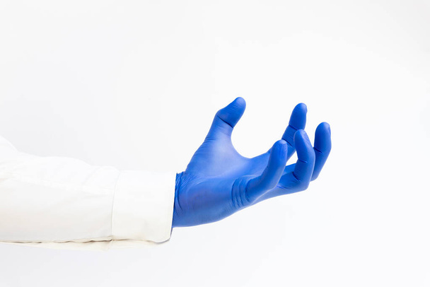 Hand in blue latex Glove grabing. Copy space, white background - Foto, Imagem