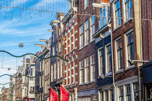 AMSTERDAM, THE NETHERLANDS - NOVEMBER 18, 2018: Urban landscape, typical Dutch architecture in Amsterdam, the Netherlands - Fotografie, Obrázek