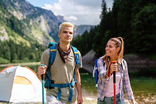 Happy hiker group of friends trekking as part of healthy lifestyle outdoors activity - Valokuva, kuva