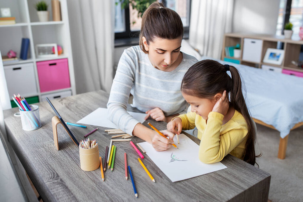 mother with little daughter drawing at home - Photo, Image