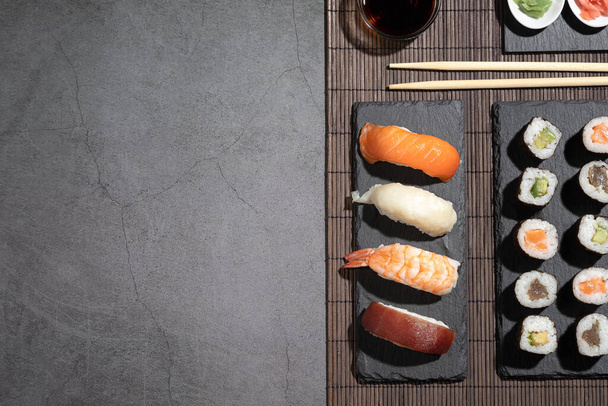 Variety of sushi on dark background. Sushi set with copyspace. - Photo, Image
