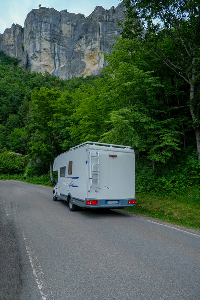 White camper car driving in the mountains. Adventurous lifestyle. Camper life. Travel in mountains - Photo, Image