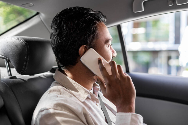 male passenger calling on smartphone in taxi car - Photo, image