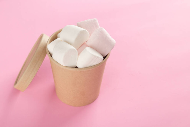 Marshmallow in bucket on pastel pink background. - Photo, Image