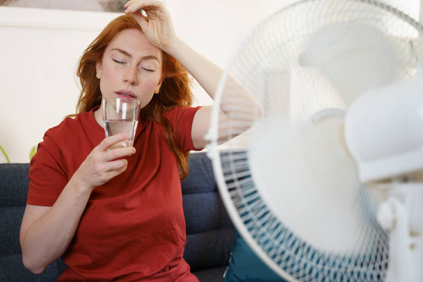 One woman suffering for summer heatwave at home - Photo, Image