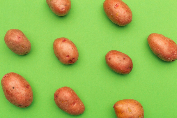 Potato on a colored background. Pattern of potato. - Photo, image